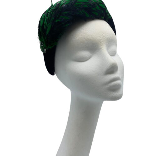 Stunning emerald green and black feather crown with little jewel detail to finish.